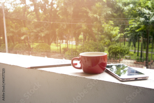 coffee cup with mobile phone in morning