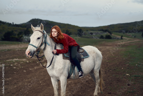 Young beautiful woman walking in the mountains with her horse © SHOTPRIME STUDIO