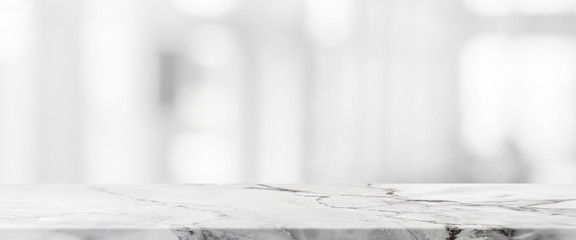 White stone marble table top and blurred abstract background from interior building banner background - can used for display or montage your products.