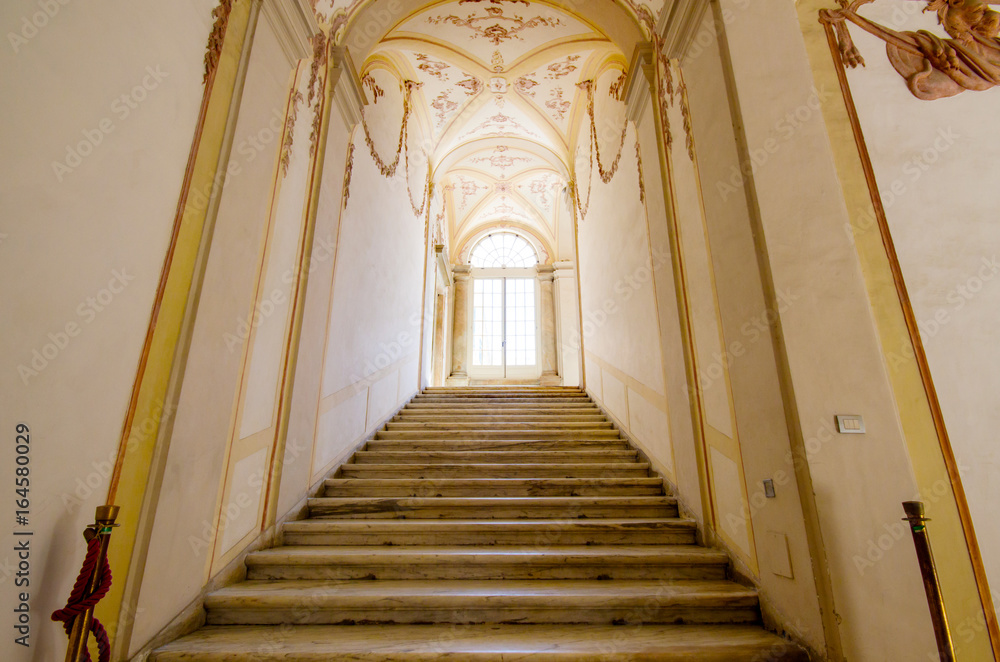 Fototapeta premium Ladder, Stair up the royal palace Genoa, Interior of Palazzo Reale in Courtyard of one of the palaces of strada nuova - doria tursi palace in Genoa, Italy , Royal palace .