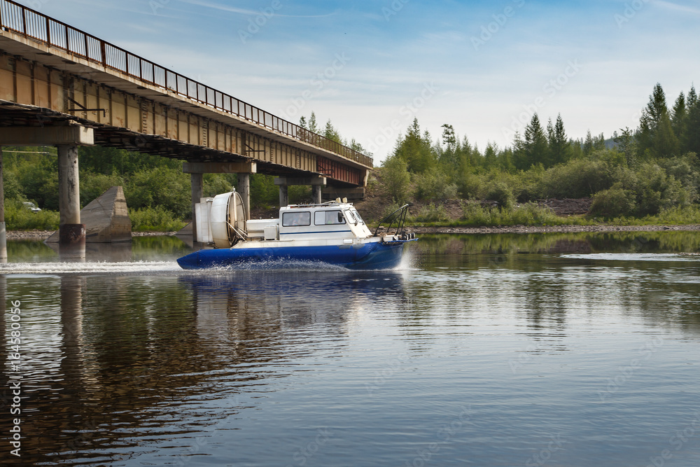 Hovercraft passes under the bridge Hovercraft passes under the bridge