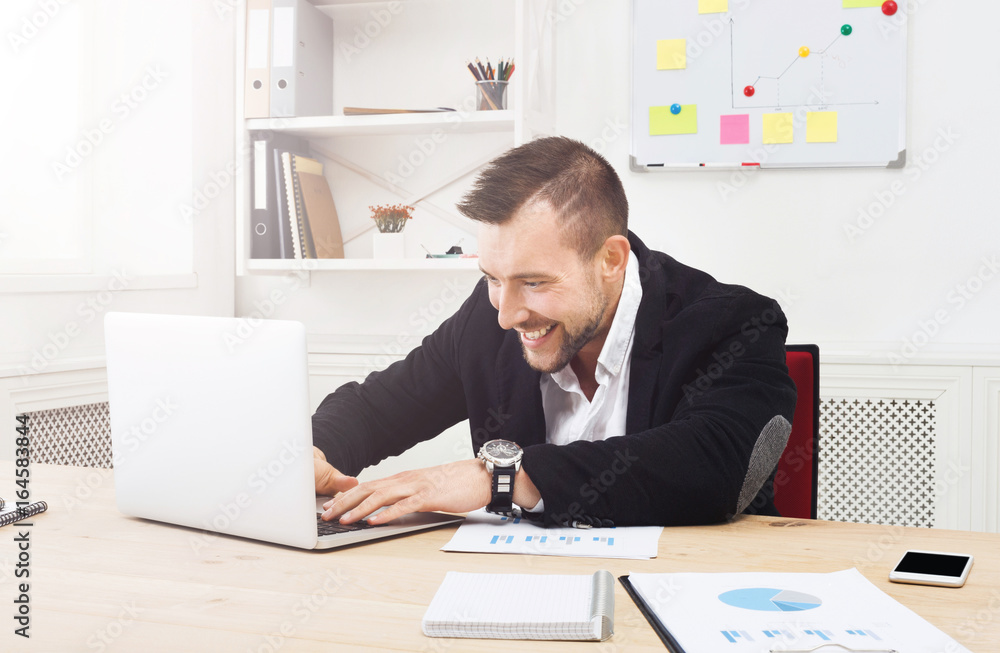 Young businessman with laptop in the office Young businessman with laptop in the office