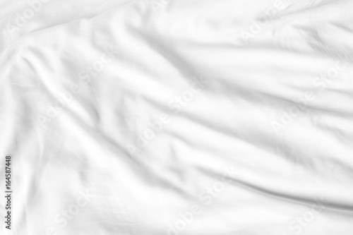 Top view of white bedding sheets after wake up in the morning
