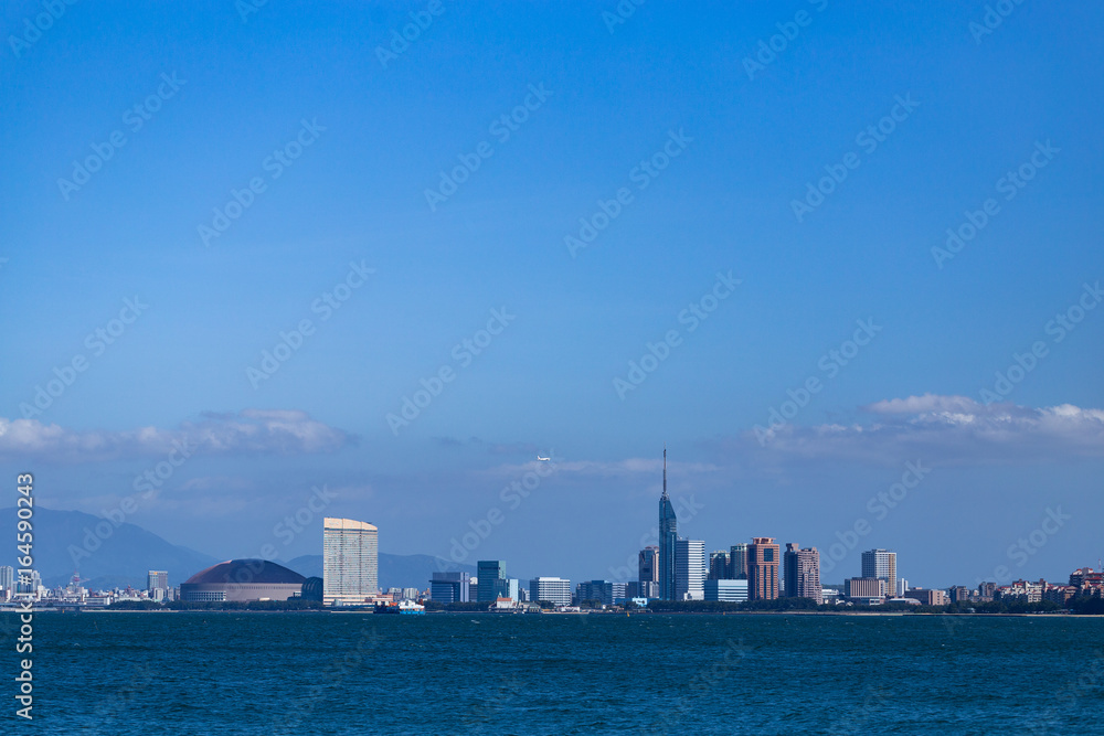 Fukuoka city scape and landmarks, Fukuoka tower and Fukuoka dome over ocean. 
