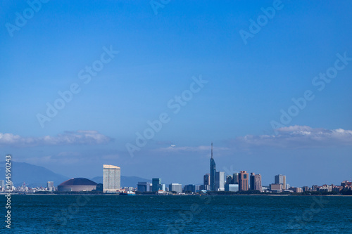 Fukuoka city scape and landmarks, Fukuoka tower and Fukuoka dome over ocean.    © Tetsuya