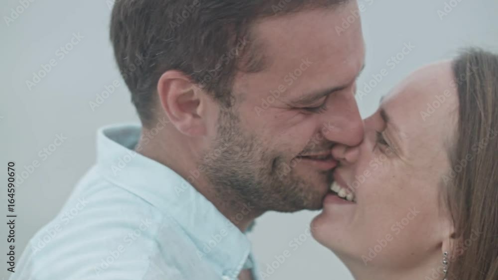 Portrait of the happy family couple kissing on the shore Portrait of the happy family couple kissing on the shore