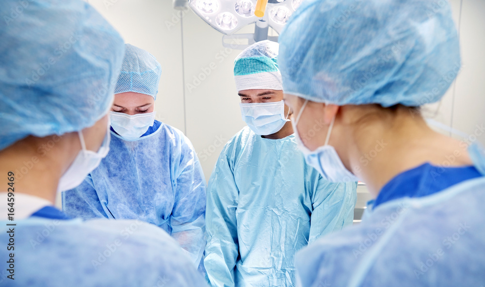 group of surgeons in operating room at hospital