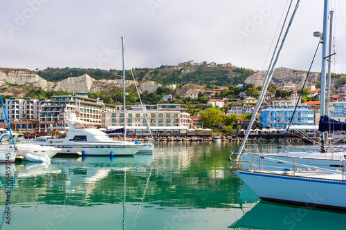 Yachts, sailing boats and pleasure boats are moored in marina of Balchik city in black sea coast at Bulgaria