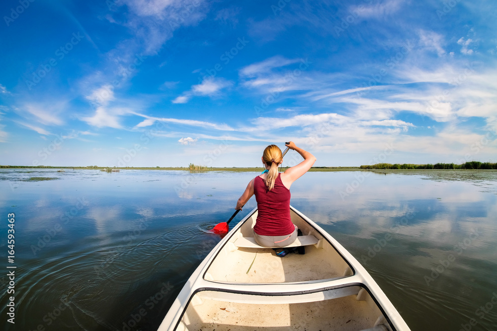 Woman sailing in Danube Delta with a boat Woman sailing in Danube Delta with a boat