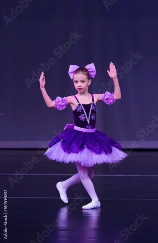 Little girl dancing ballet Coppelia variation on stage