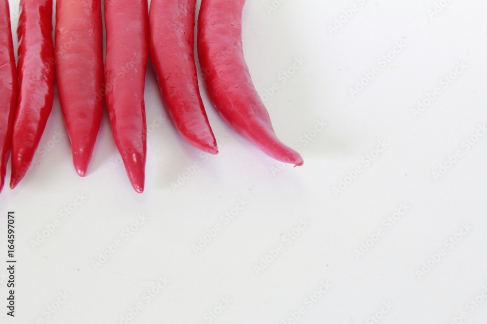 Pepper is a spicy food. Several chilies on a white background. Pepper is a spicy food. Several chilies on a white background.