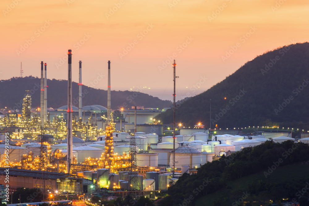 Fototapeta premium Oil refinery tanks and pipes at twilight