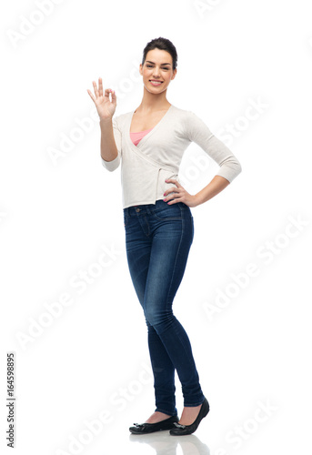 happy smiling young woman showing ok hand sign