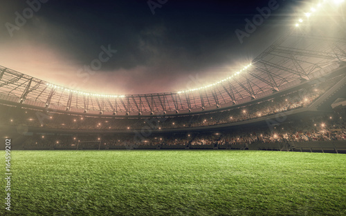 soccer stadium at night with illumination lights and dramatic sky © TandemBranding
