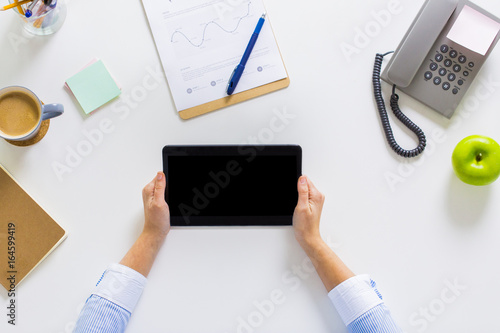 hands of businesswoman with tablet pc at office