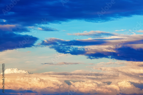 Scenic sunset sky with picturesque cumulus clouds.