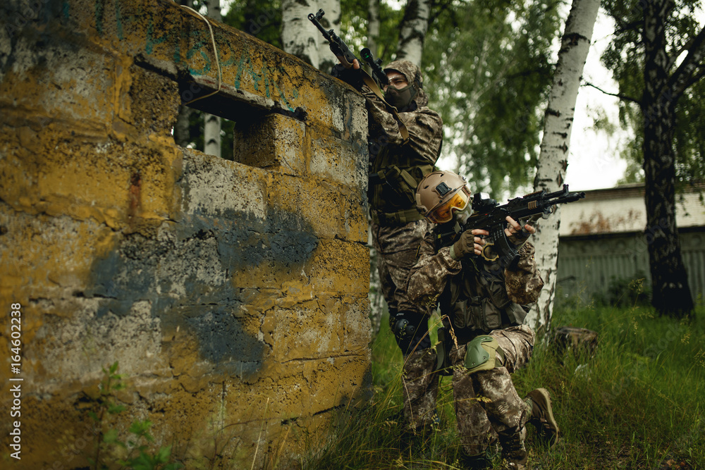 Fototapeta premium Photo of soldiers with gun