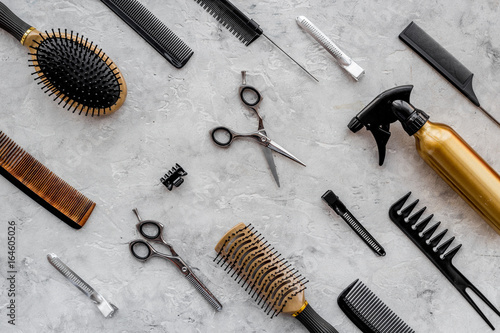 Canvas Print Pattern of combs and hairdresser tools on grey table background top view