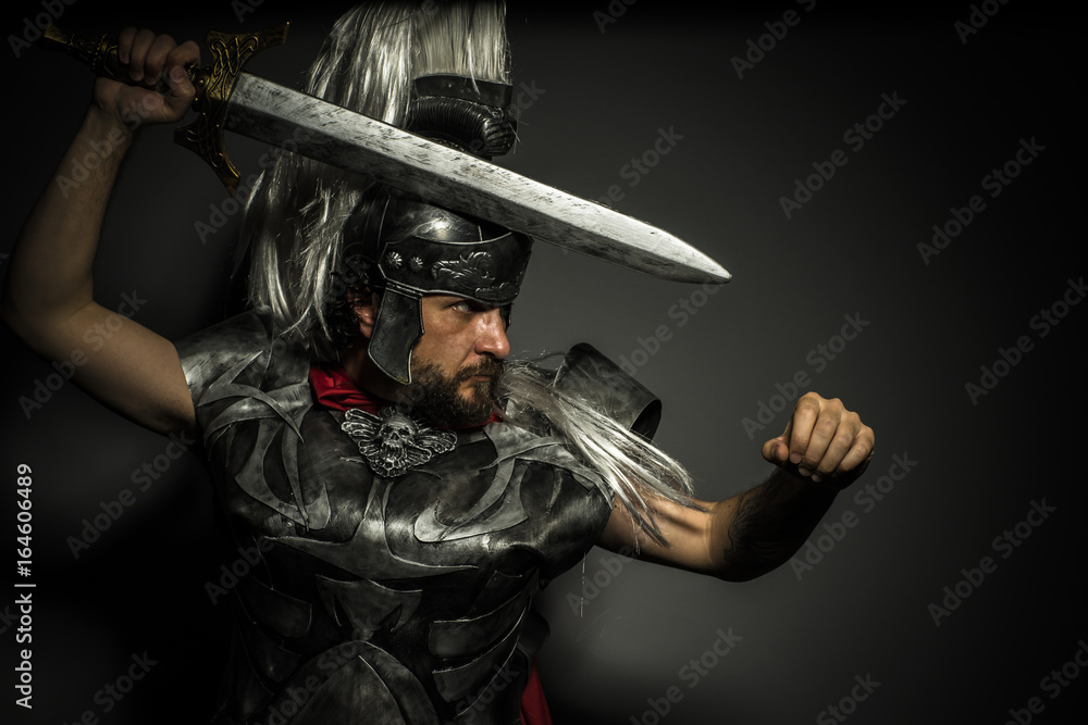 Fotografie Gladiator, Roman centurion with armor and helmet with white chalk, steel sword a