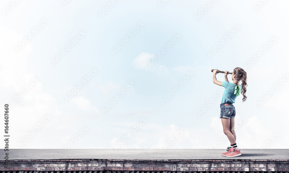 Concept of careless happy childhood with girl exploring this wor Concept of careless happy childhood with girl exploring this wor