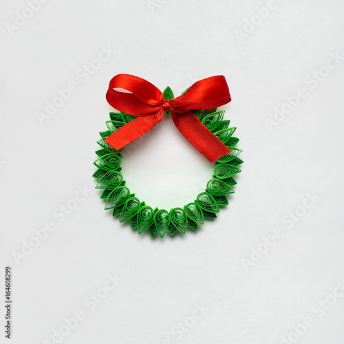 Christmas wreath / Creative concept photo of christmas wreath made of quilling paper on white background. photo