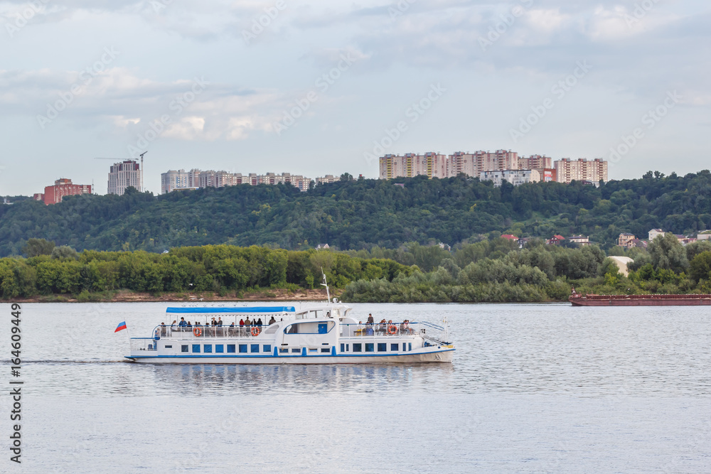A pleasure boat sails along the Volga River A pleasure boat sails along the Volga River