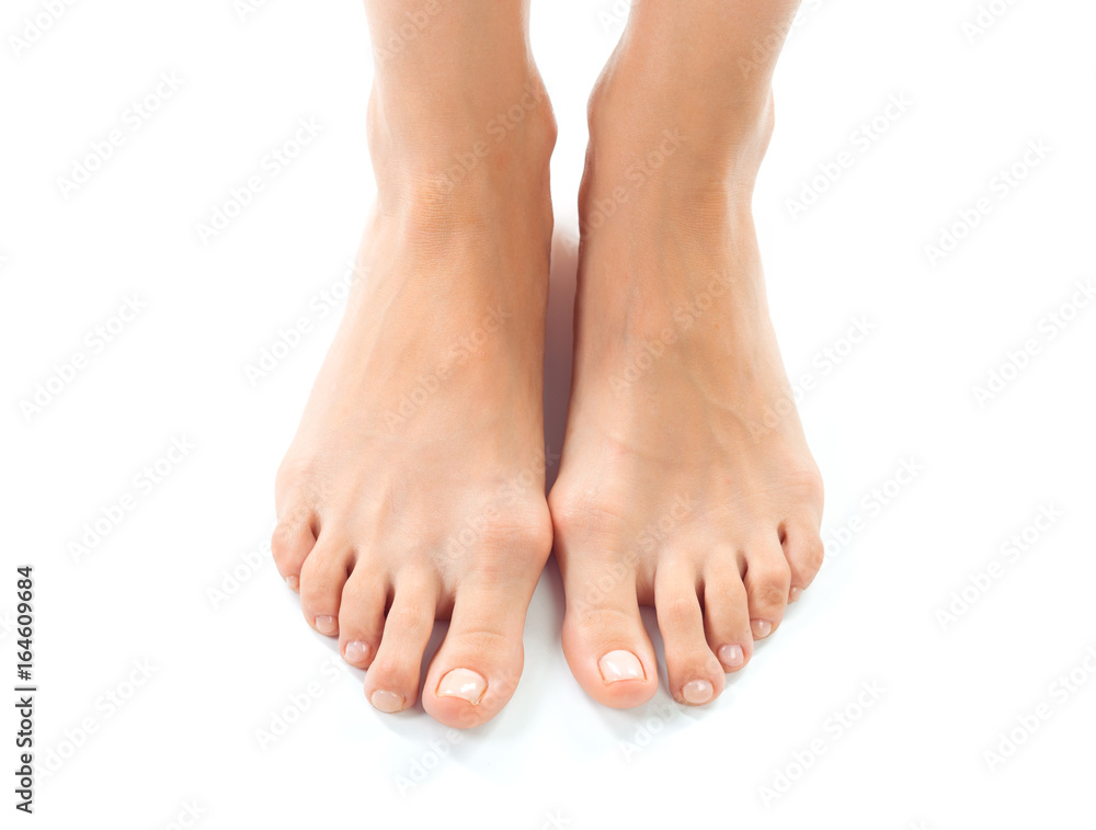 Beautiful women feet isolated on white close-up Beautiful women feet isolated on white close-up