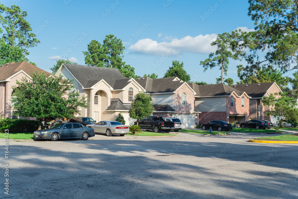 Suburban residential street with row of modern townhomes in Humble