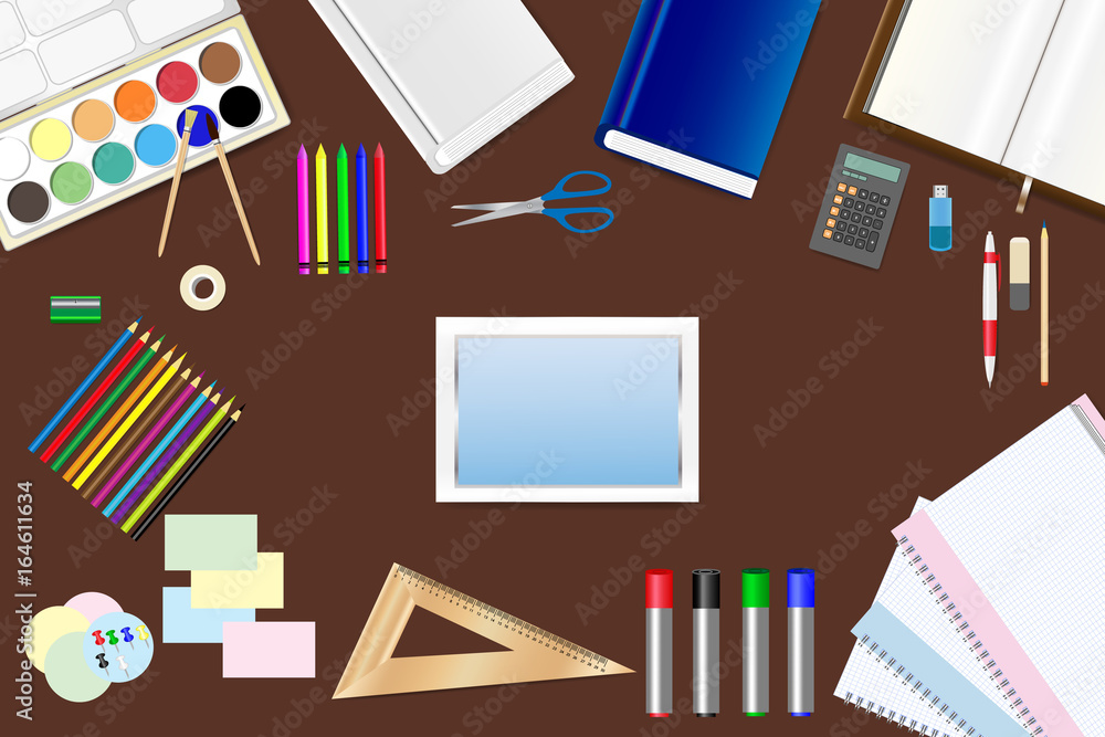 School supplies, tablet with empty screen and tools are lying on a brown wooden table. School supplies, tablet with empty screen and tools are lying on a brown wooden table.