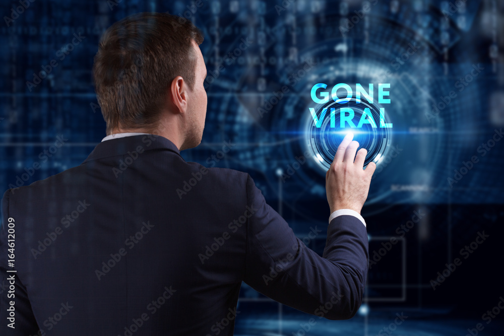 Business, Technology, Internet and network concept. Young businessman working on a virtual screen of the future and sees the inscription: Gone viral Business, Technology, Internet and network concept. Young businessman working on a virtual screen of the future and sees the inscription: Gone viral