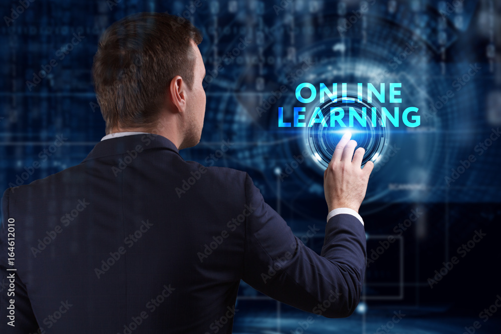 Business, Technology, Internet and network concept. Young businessman working on a virtual screen of the future and sees the inscription: Online learning Business, Technology, Internet and network concept. Young businessman working on a virtual screen of the future and sees the inscription: Online learning