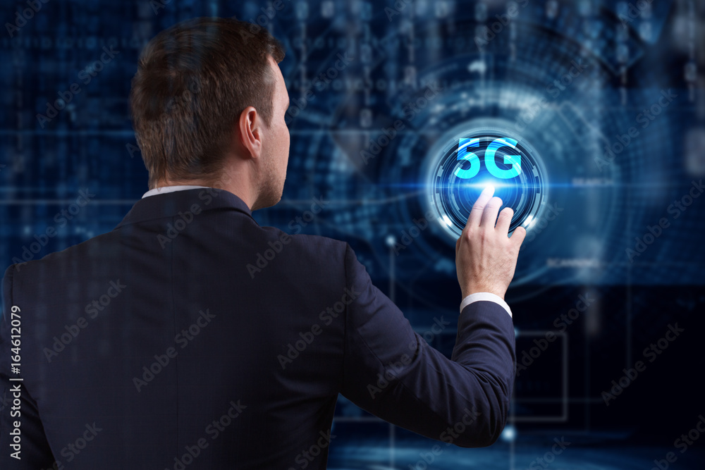 Business, Technology, Internet and network concept. Young businessman working on a virtual screen of the future and sees the inscription: 5G Business, Technology, Internet and network concept. Young businessman working on a virtual screen of the future and sees the inscription: 5G