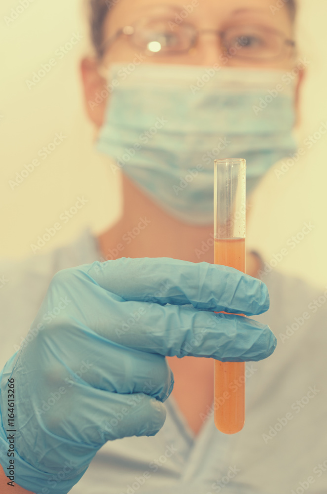The doctor makes tests with a biological fluid. The doctor makes tests with a biological fluid.