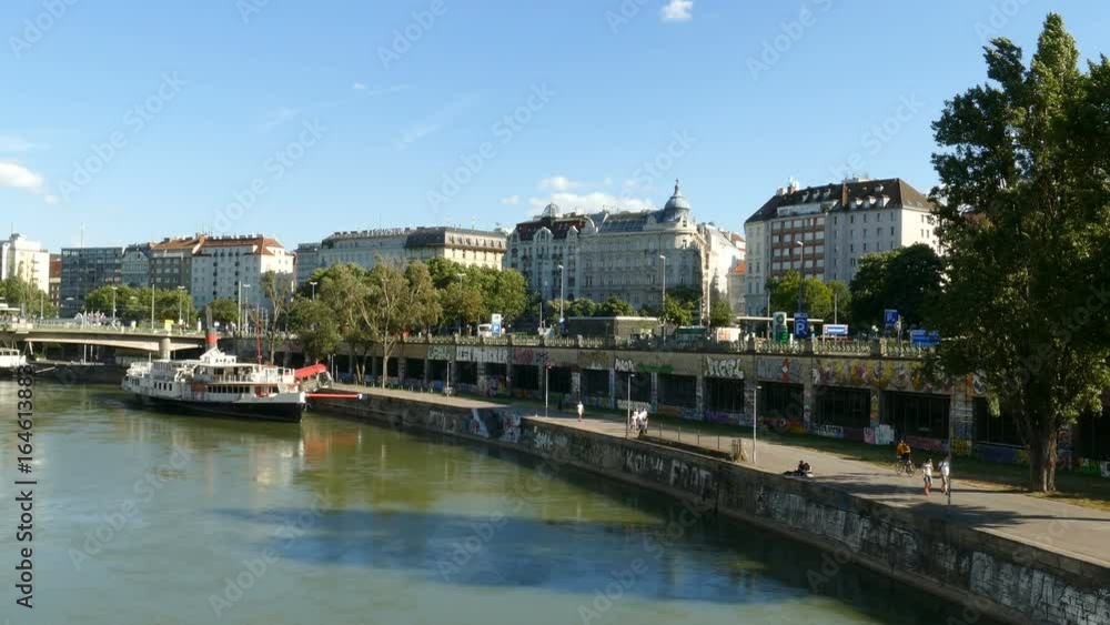 People walking along the Donau river in Vienna, Austria People walking along the Donau river in Vienna, Austria