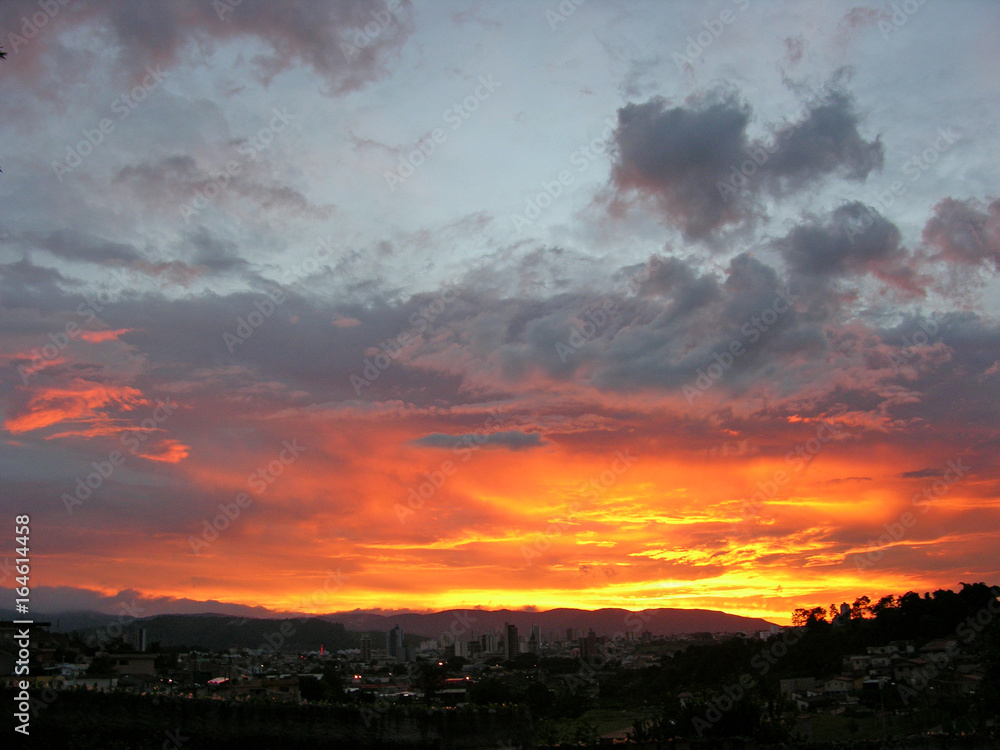 fire in the sky over the city and mountais - unretouched