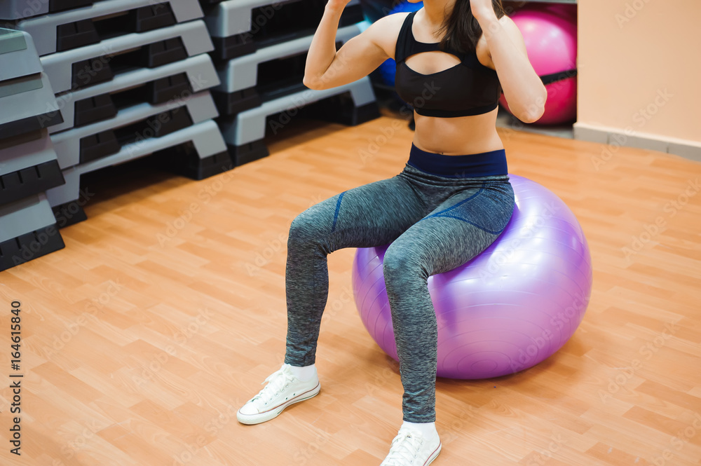 Pretty sexual straight fitness woman with musculat body lying on big ball in sport hall training indoor, horizontal picture Pretty sexual straight fitness woman with musculat body lying on big ball in sport hall training indoor, horizontal picture