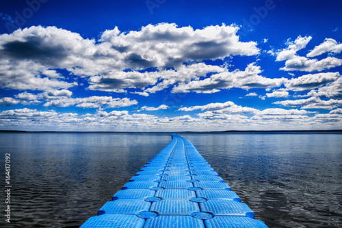 Long pier on blue lake photo