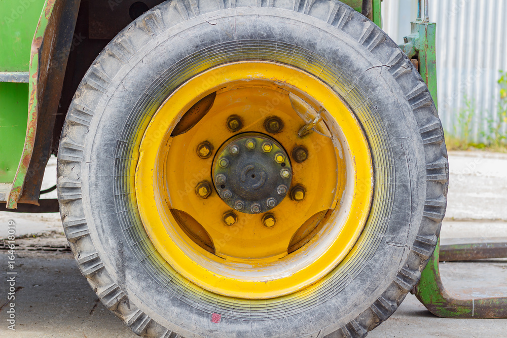 Front wheel of old forklift truck closeup