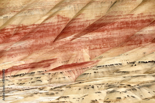 Surrealistic landscape of the slopes of Painted Hills in the John Day Fossil Beds National Monument. View from hiking trail.