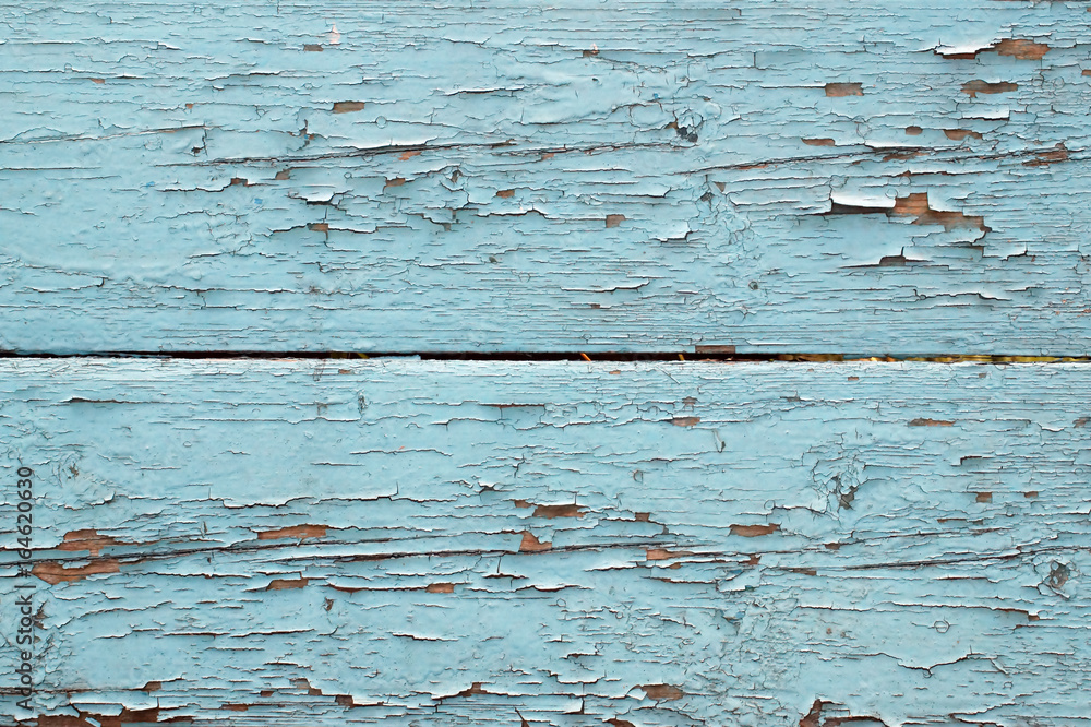 Wooden bars, painted in blue color with cracked and peeling paint.