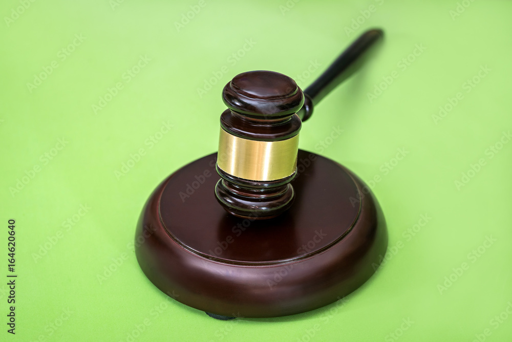 Law symbols  -  gavel isolated on green background