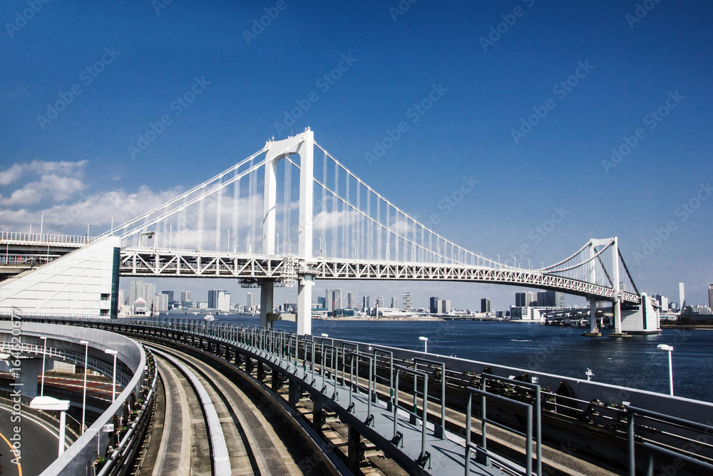 Railway bridge construction in Tokyo with blue sky in the background. Railway bridge construction in Tokyo with blue sky in the background.