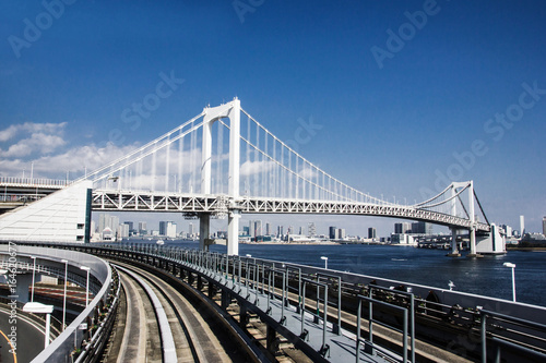 Railway bridge construction in Tokyo with blue sky in the background. 