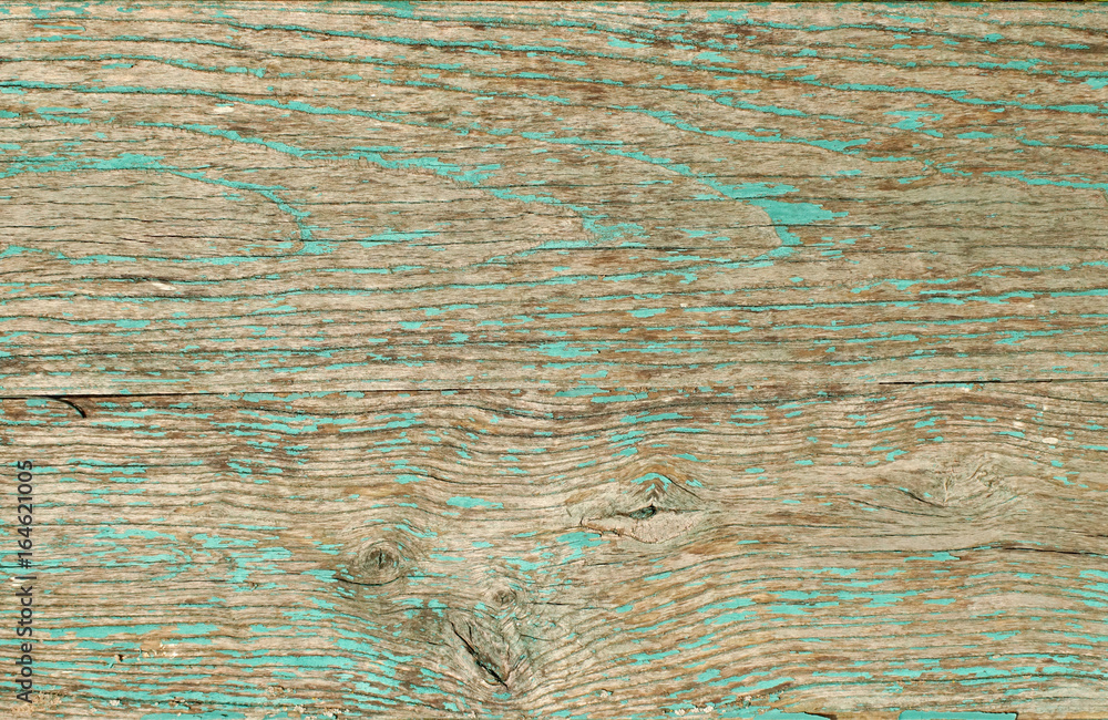 Wooden board, painted in green color with cracked and peeling paint.