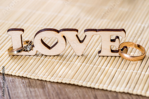 wedding concept - text love with golden ring