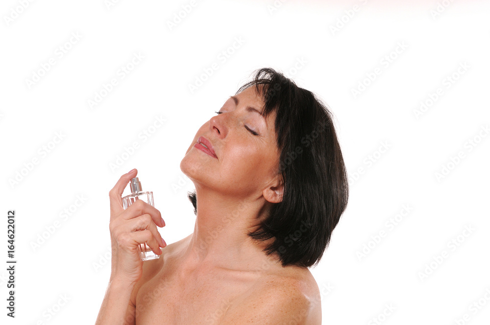 Mature well groomed woman with bottle of perfumes Mature well groomed woman with bottle of perfumes