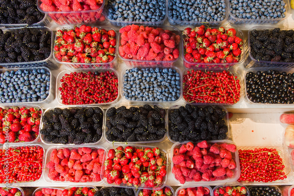 Fresh berries on display. Organic and fresh. Food background. Display on local farmers market. Fresh berries on display. Organic and fresh. Food background. Display on local farmers market.