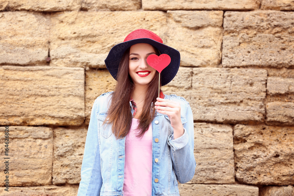 Beautiful young woman with bright lips on brick wall background Beautiful young woman with bright lips on brick wall background