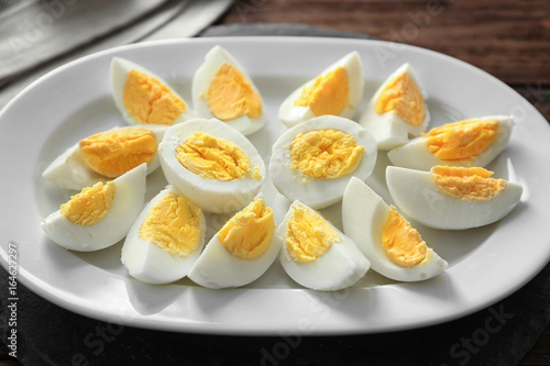 Hard boiled sliced eggs on plate. Nutrition concept