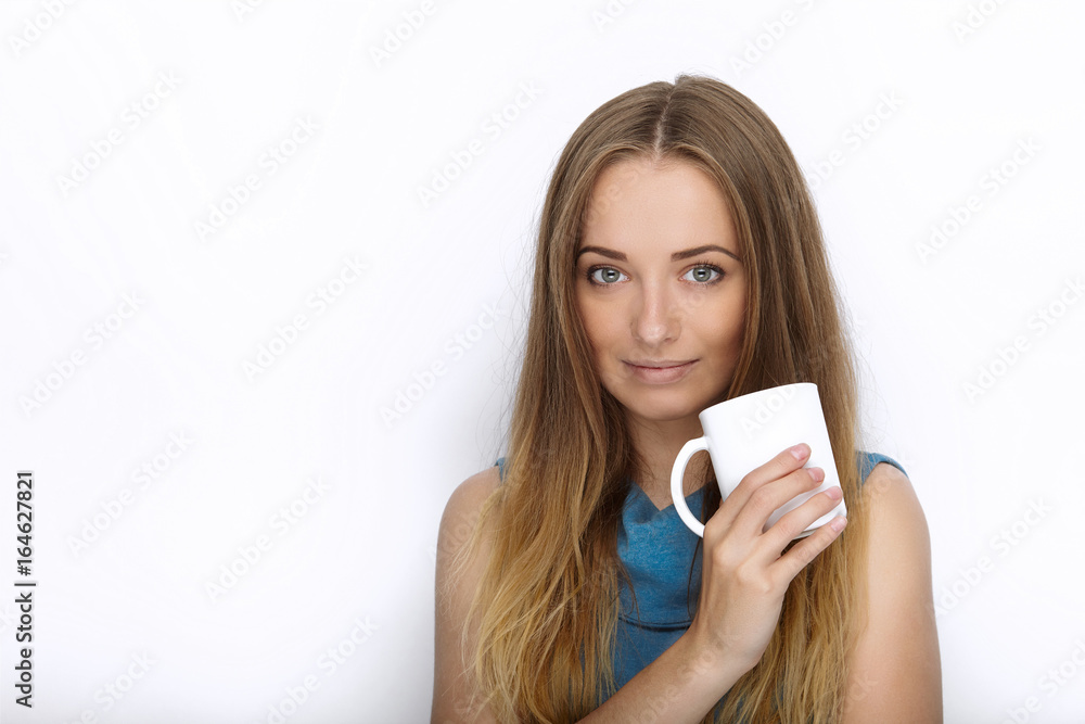 Headshot of young adorable playful blonde woman with cute smile in cobalt color blouse posing with big pure white mug on white backdrop Headshot of young adorable playful blonde woman with cute smile in cobalt color blouse posing with big pure white mug on white backdrop